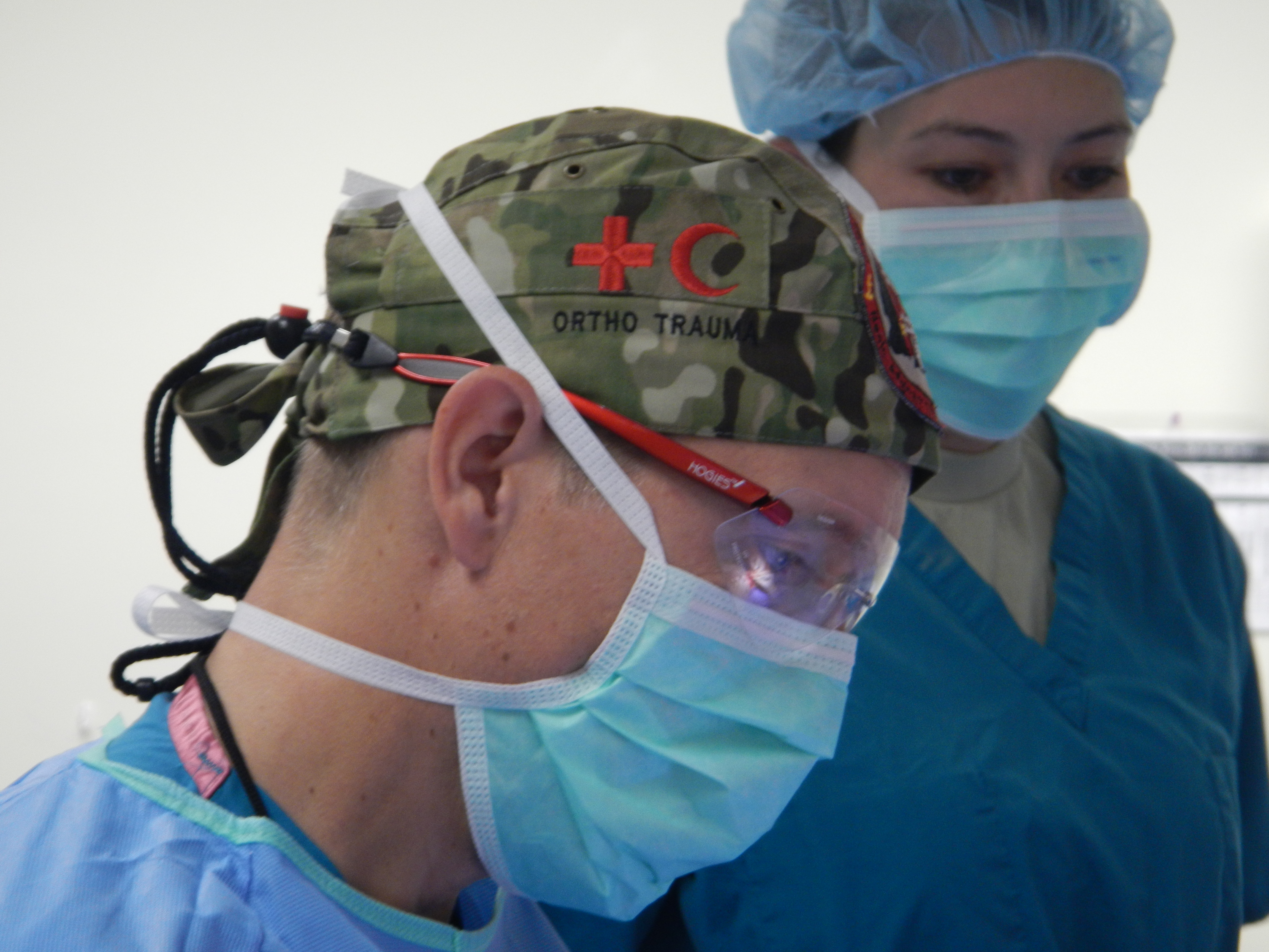 An officer and a surgeon: Commander Ian Young gets to work at Kandahar Airfield.