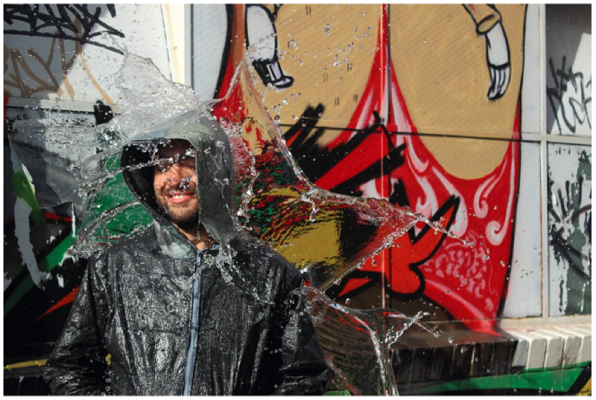 Marulanda takes cover in his recycled raincoat. Photo: Hernan Lopera