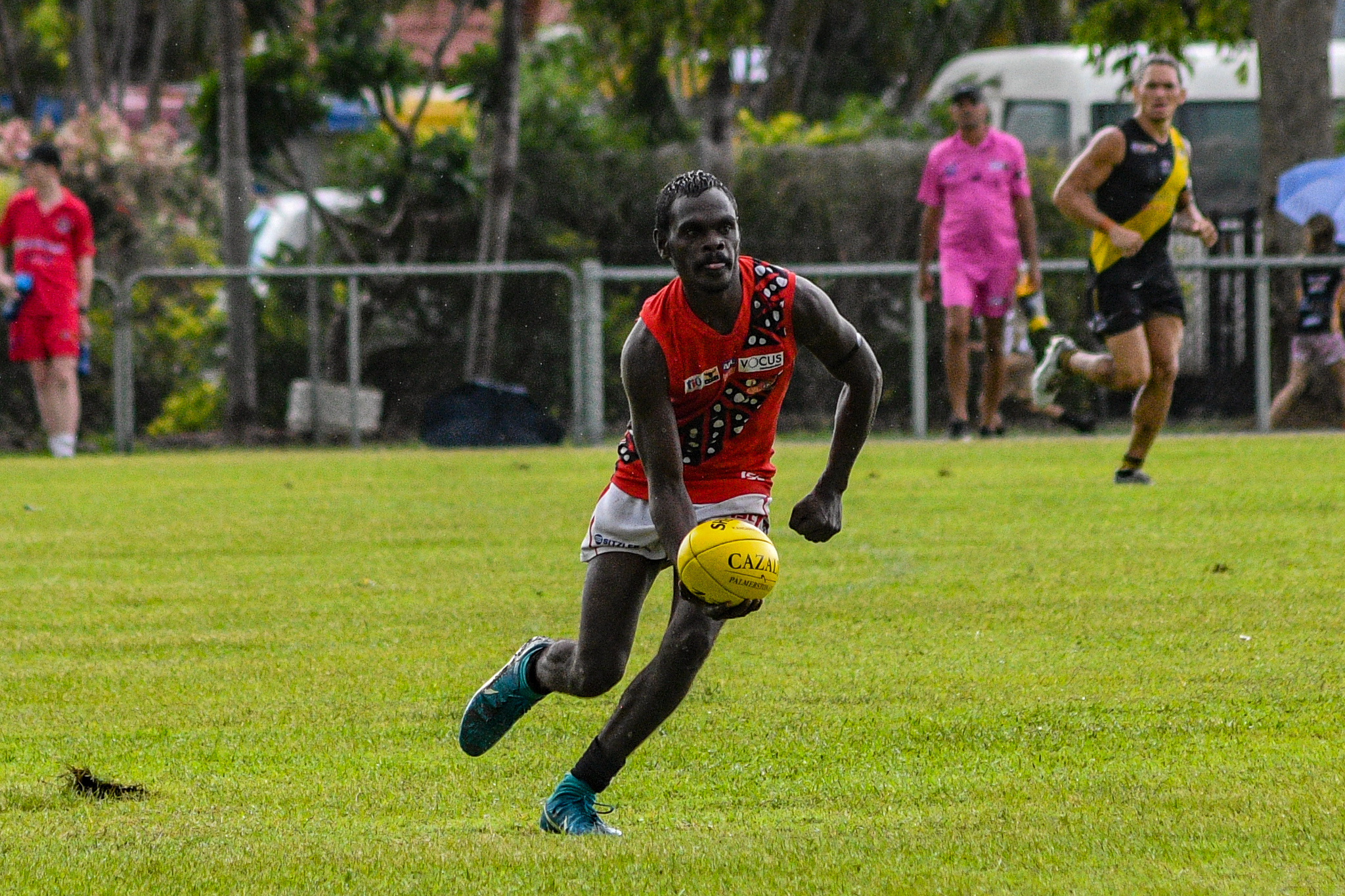 Randy Mungatopi shapes to handball. Tiwi Bombers v Nightcliff Tigers, NTFL round 15, January 27, 2019.