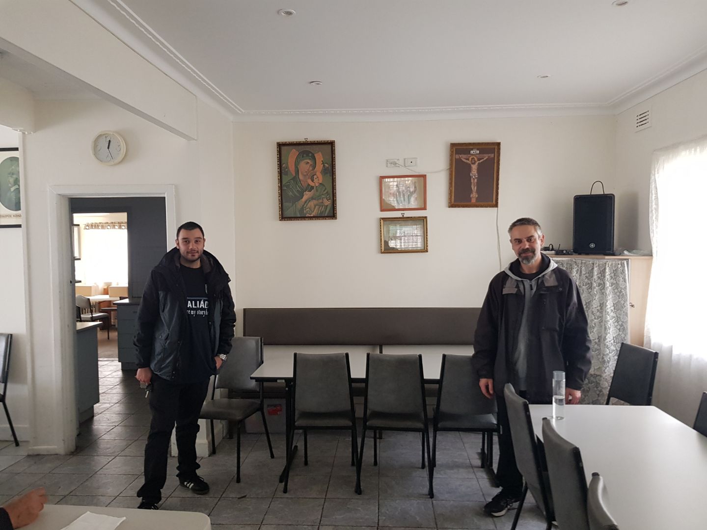 Peter Koulouris, left, and Bill Pagomenos, keep their required social distance. Thanks to their efforts, remote attendance at services is booming. “It’s a humble set-up,” says Pagomenos, of the live-stream technology. “Literally a tripod for a phone with a piece of paper jammed in so the phone doesn’t move, and an extension cord so the battery doesn’t go flat.” Picture: Supplied