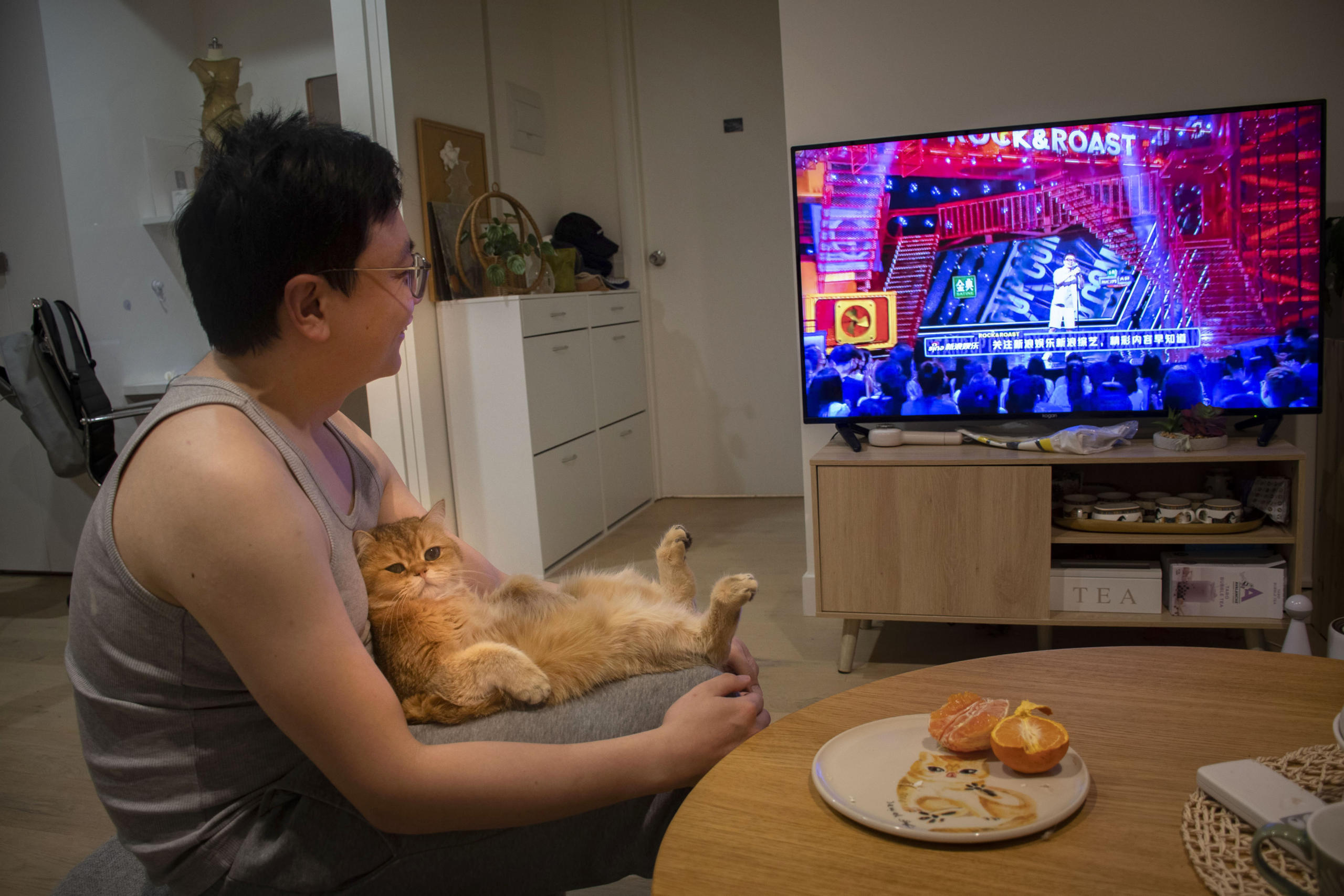 Jewel enjoys sitting on Peng Wu&rsquo;s lap while he watches his favourite TV show Rock & Roast. He bought Jewel during the first lockdown in Melbourne as a tiny kitten. Peng says nurturing Jewel has given him a sense of accomplishment. &ldquo;Since then, I feel much happier because I have someone to take care of and play with. Every morning Jewel will make a howl noise, motivating me to get up,&rdquo; Peng says. Photo: Chenlu Chen