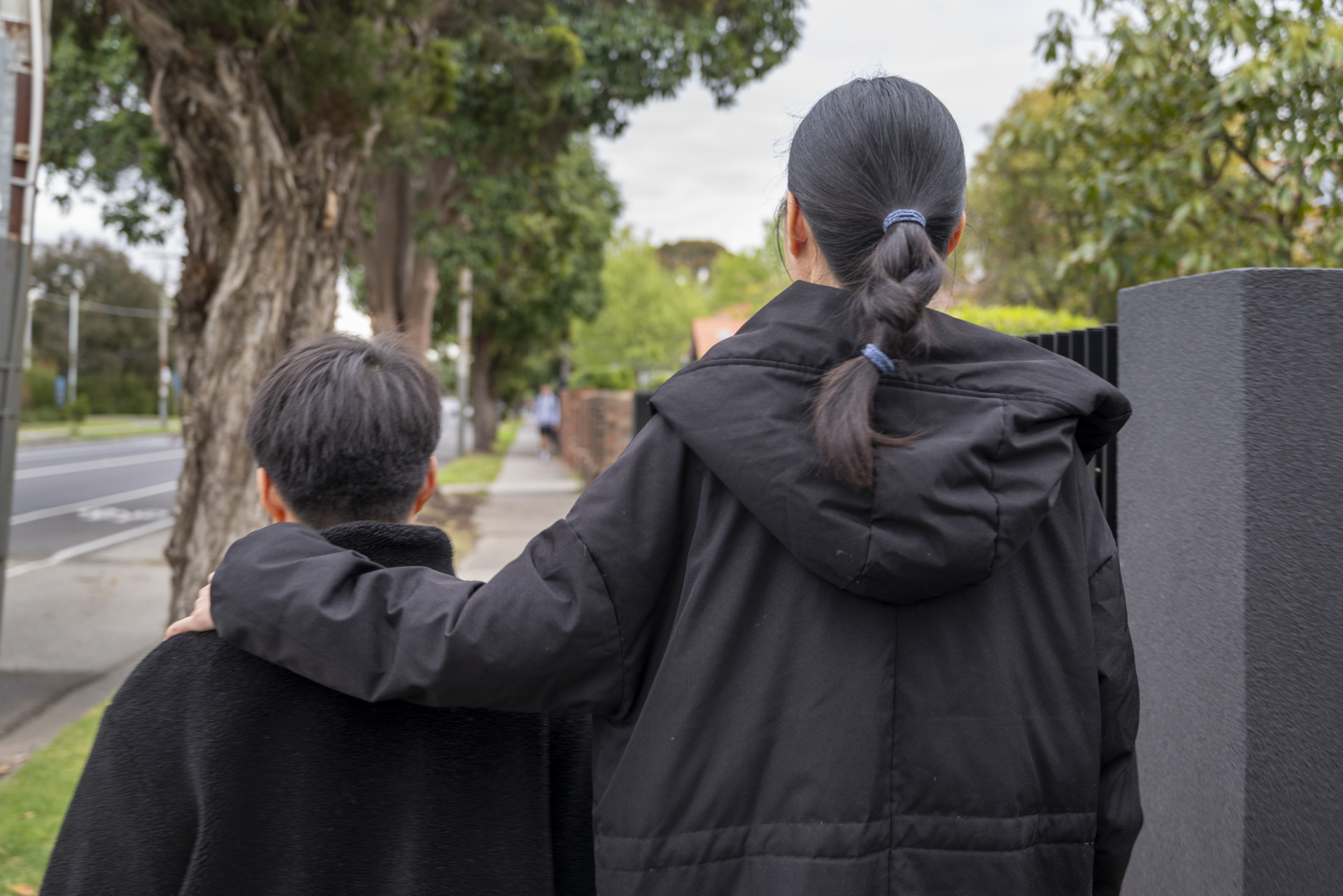 Alin Ling and her son Edward Pang walk to Edward&rsquo;s nearby primary school. Despite being on holiday, Edward wants to visit the school to play, so Ling accompanies him. Ling put her arm around Edward or held his hand as they walked.