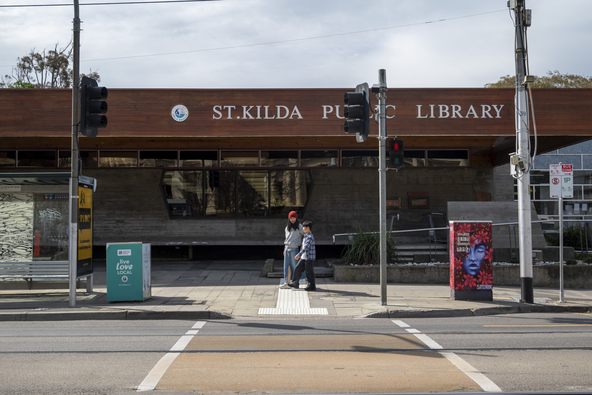 One afternoon, accompanying mother Alin Ling walks to the St Kilda Library with her son, Edward Pang. Ling regularly visits the St Kilda Library after dropping her son off at school to borrow English books and study by herself.