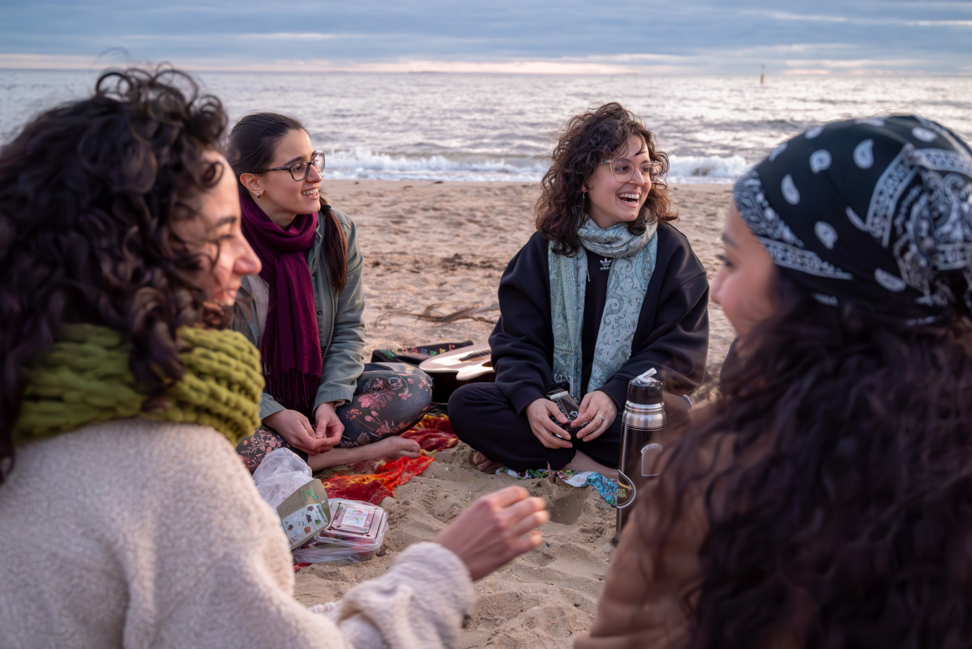 Members of the Latin American Women&rsquo;s Circle sit on St Kilda beach, laughing, sharing snacks, and chatting about their lives. Sharing their personal life journey is something they do every week, as it helps them understand one another better and build strong connections.