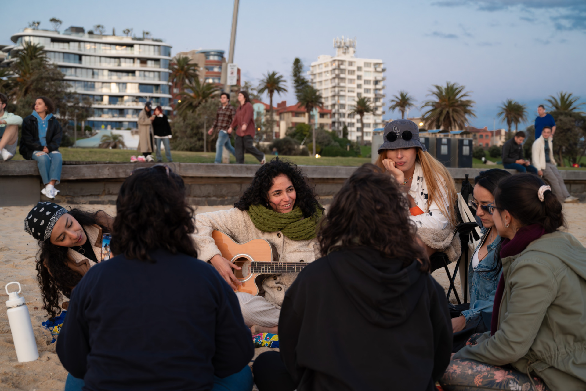 Members of the Latin American Women&rsquo;s Circle sit on St Kilda beach listening to their organiser, Carolina Romero, play the guitar, while singing Spanish songs. They all agree that music is essential for relaxation and healing. At every gathering, they bring instruments like guitars, drums, and flutes to play. Embracing their shared language in a foreign country also helps them gain a sense of belonging.