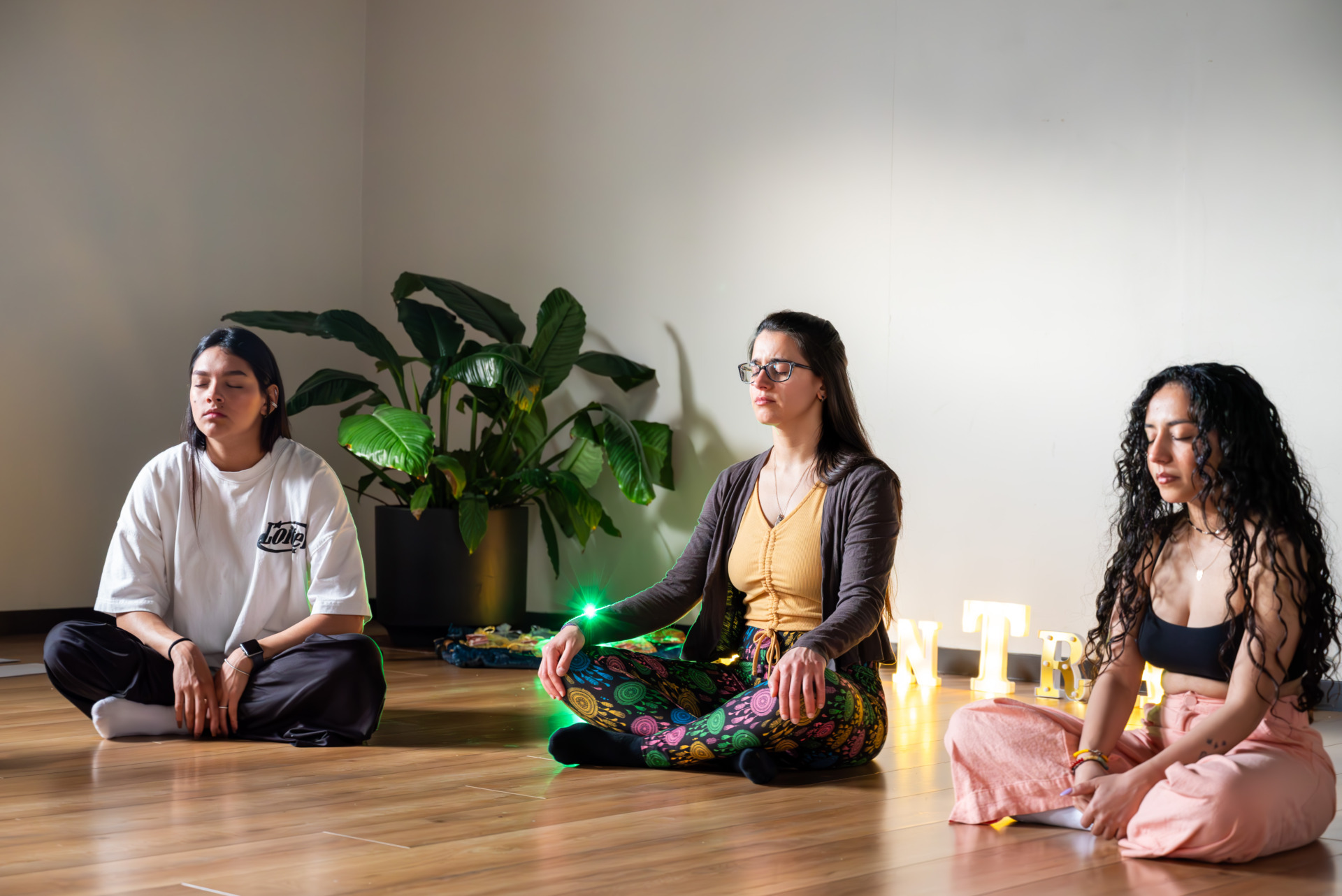The Latin American Women&rsquo;s Circle members Sofia, Maria and Ayat (from left to right) sit on the floor, practicing meditation, imagining their inner child and engaging in a conversation with the child in their mind. As they take deep breaths, everyone is encouraged to share their feelings, whether of joy or sadness, allowing their emotions to flow freely in the space.