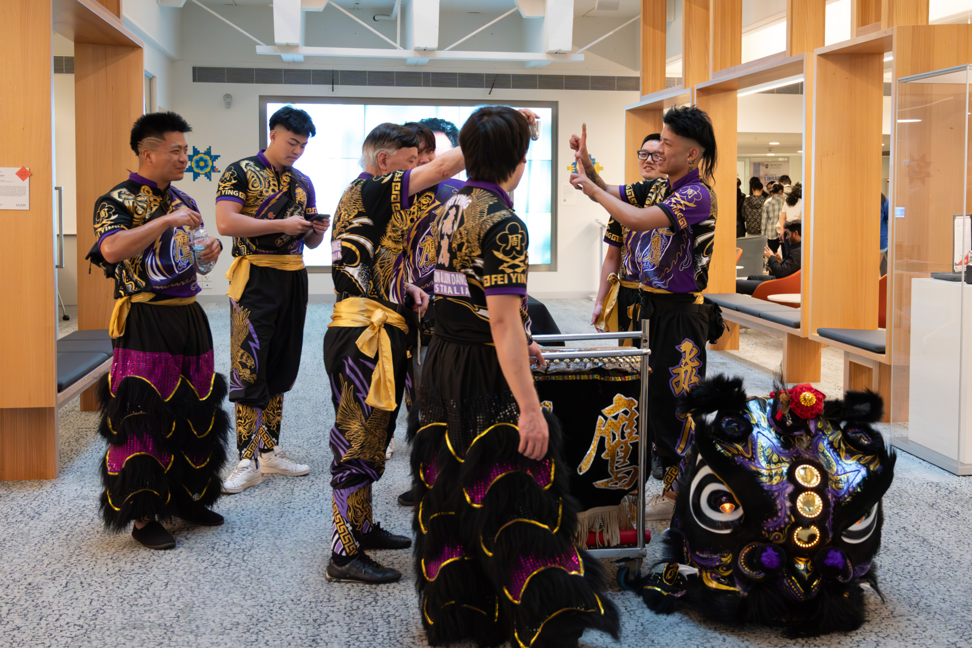 18 October 2024. Group members prepare for the performance at the Caulfield campus of the Monash University library, Melbourne, Australia. Former members of Jow Ga Kuen Martial Arts Association have come to support Feiying&rsquo;s performance at the university. They wear Feiying&rsquo;s costumes and perform with them. After the performance, they celebrate together and share their joy and sense of accomplishment.