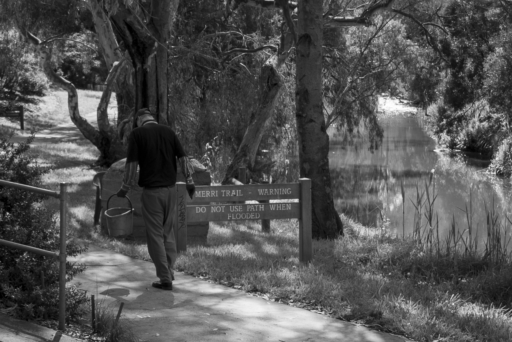 A Friends of Merri Creek volunteer, Ian collecting water to tend to plants near Ida Street, Coburg North. The Merri Creek runs from Wallan all the way through Melbourne&rsquo;s northern suburbs. Many locals use the creek trail for exercise, commuting and leisure. Most creek maintenance is done by community volunteers. Photo by Ruby Perryman