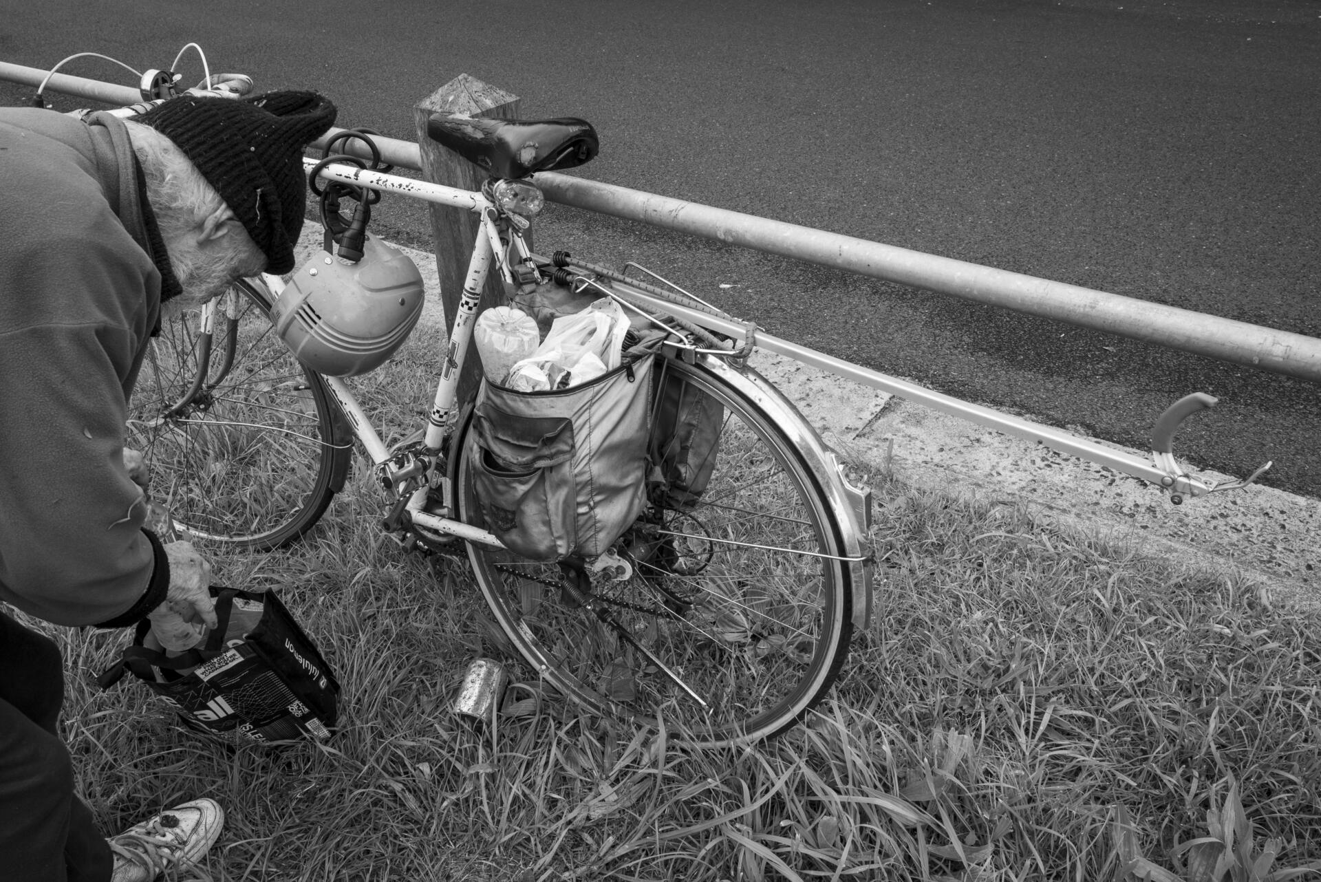 Friends of Merri Creek volunteer, Paul Prentice packing his bike panniers with rubbish near Clara Street, Brunswick East. Prentice, 83 has been cleaning the Merri Creek for over 30 years. He takes recyclables home to wash and sort correctly. Most creek maintenance is done by community volunteers. Photo by Ruby Perryman