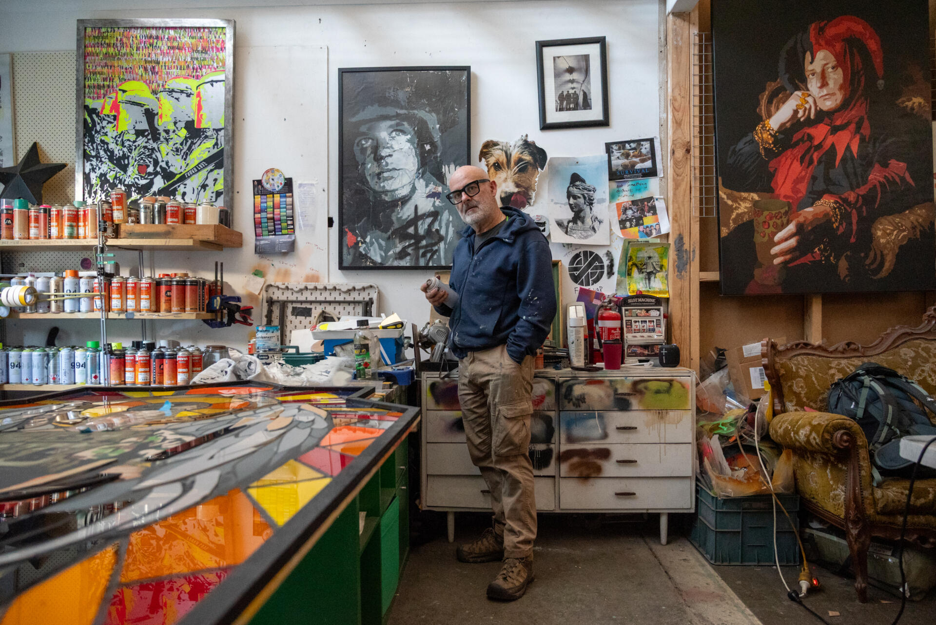 Sean Burton in his studio at FML. Behind him hangs Babs, a well-known stencil piece based on a photograph he took of a fellow soldier during service. &ldquo;I like to use everyday serving people as the basis for my work,&rdquo; he said. &ldquo;I hope it becomes something their children can remember them by.&rdquo;
