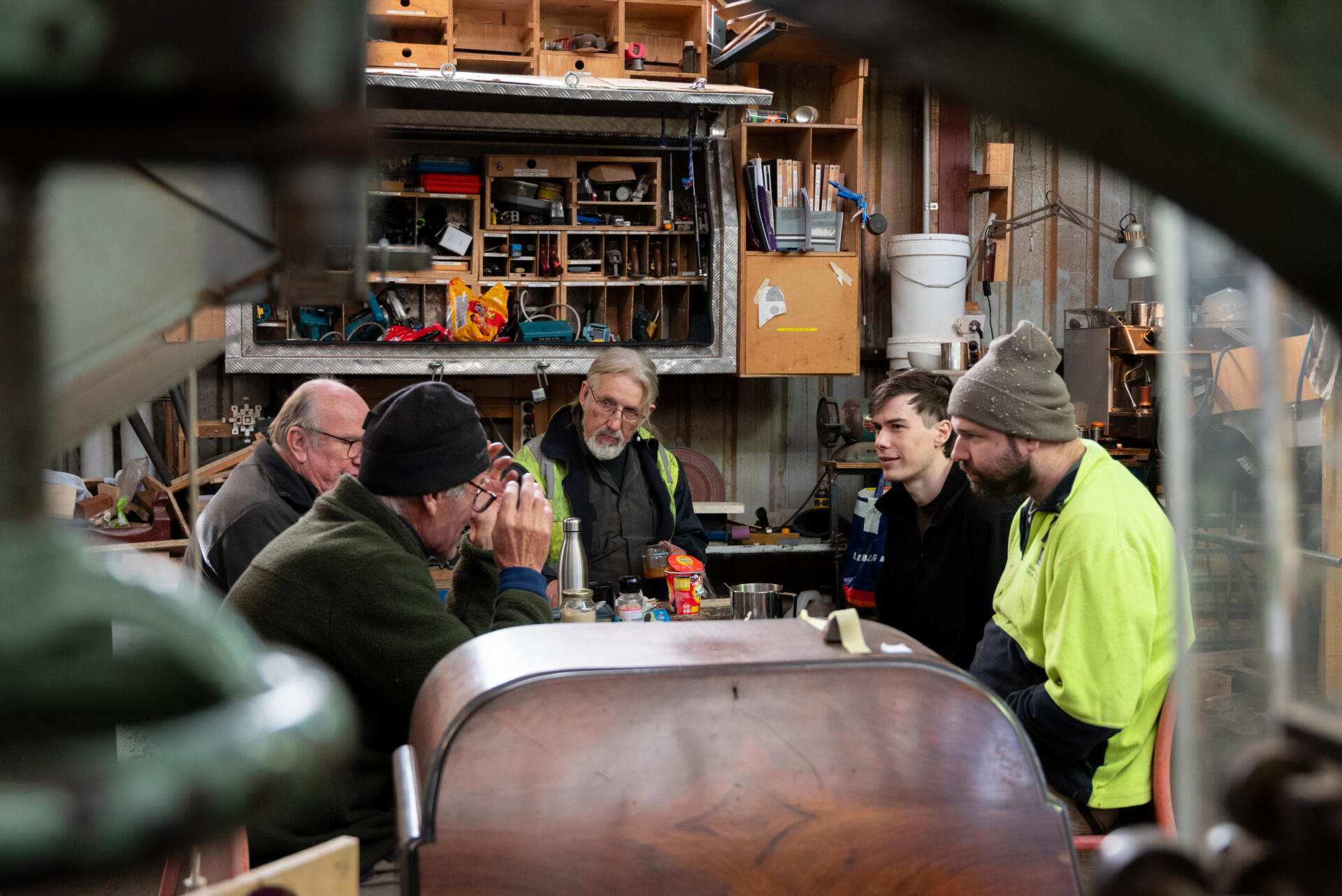 Members gather for lunch inside Scott&rsquo;s studio. These lunch breaks are casual and relaxed, with people drifting in one after another, bringing their food, and chatting about work and life.