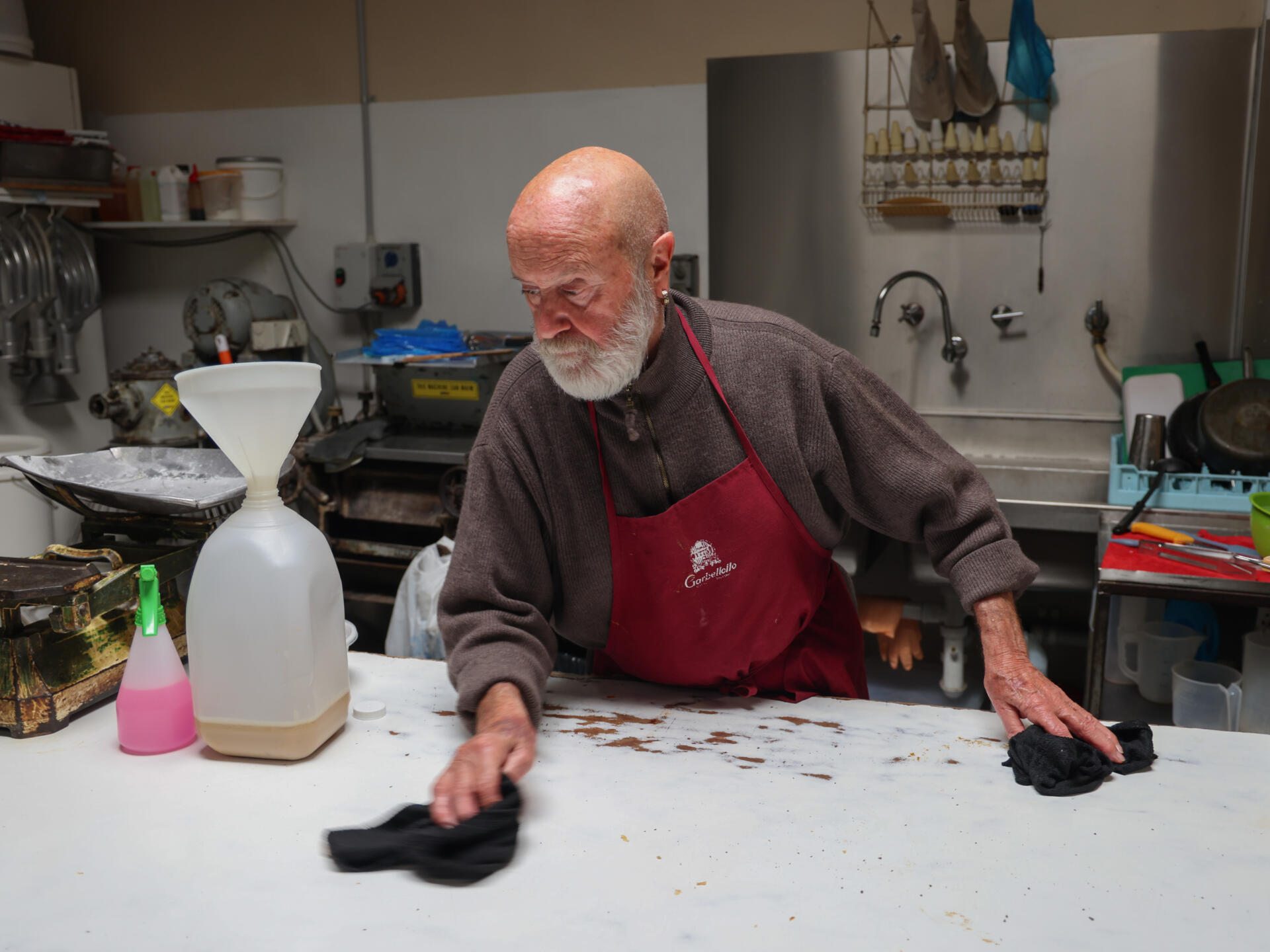 John cleans tables after the lunchtime rush.