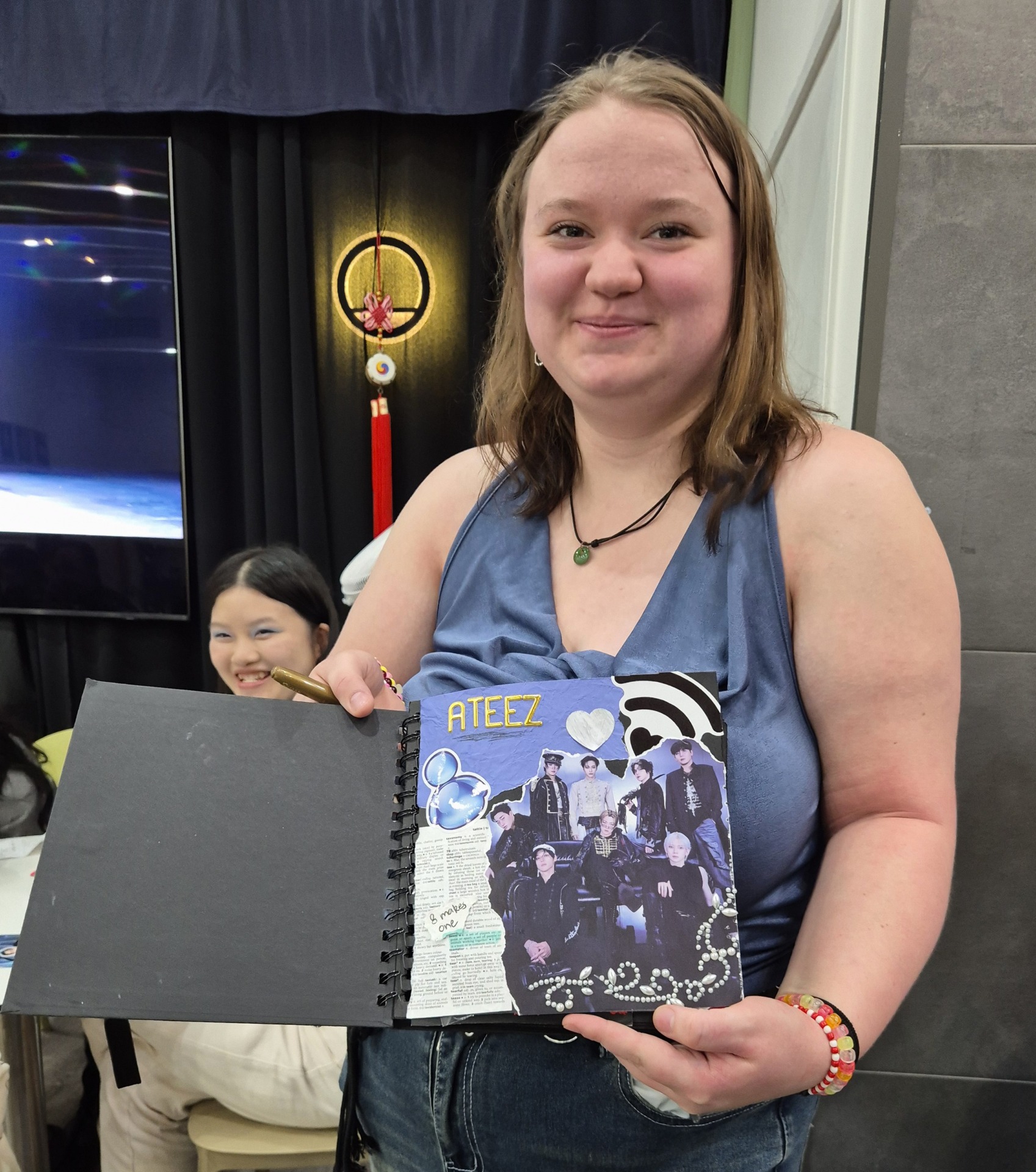 Brie Fisher at a cupsleeve event with her notebook. Image: Ying Xin.