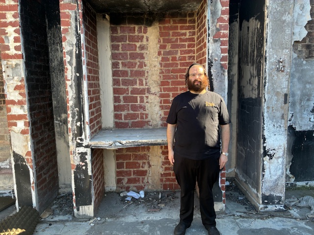 Aharon Fried stands in front of the place where the Torah scrolls were kept inside the synagogue. Photo by Lewis Weir.