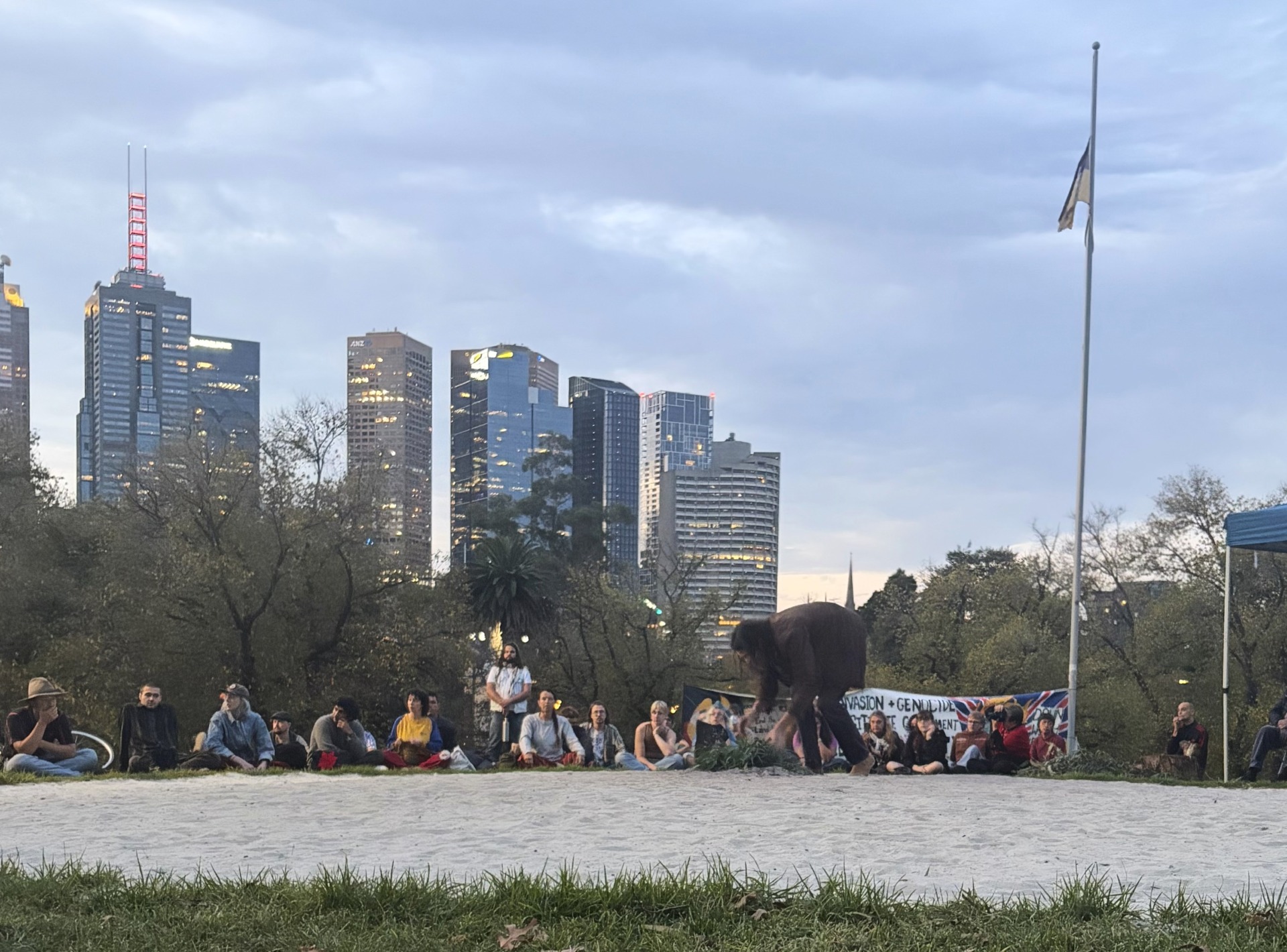 An organiser lays the first branches for the ceremonial fire. Photo: Matt Melia.