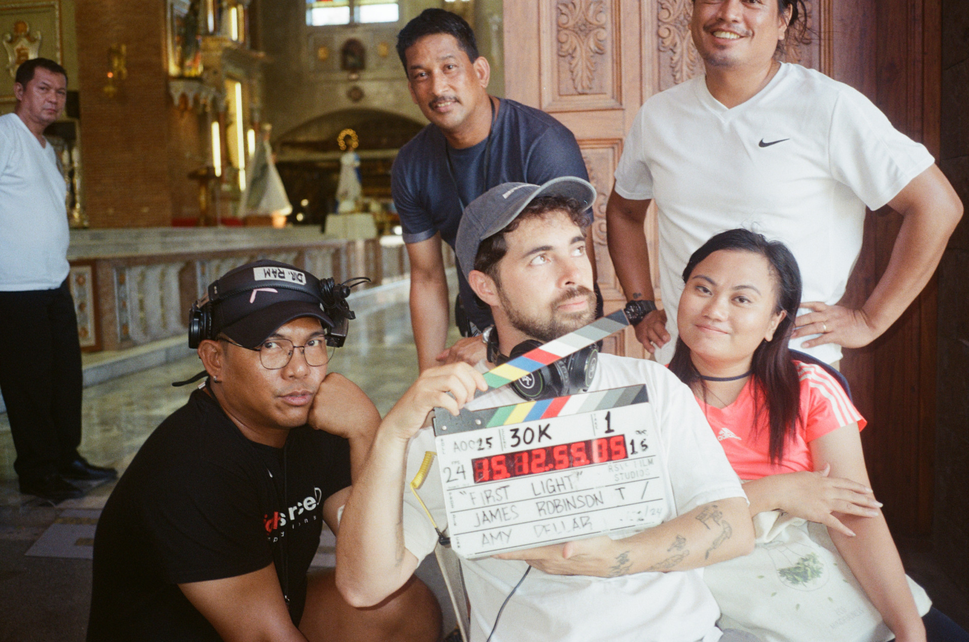 <em>First Light</em> (2025) director James J Robinson on-set with crew. Supplied.